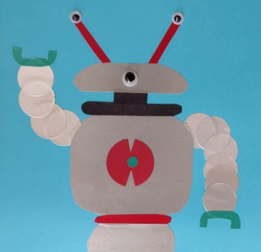 Robot made from pieces of white paper on a blue background