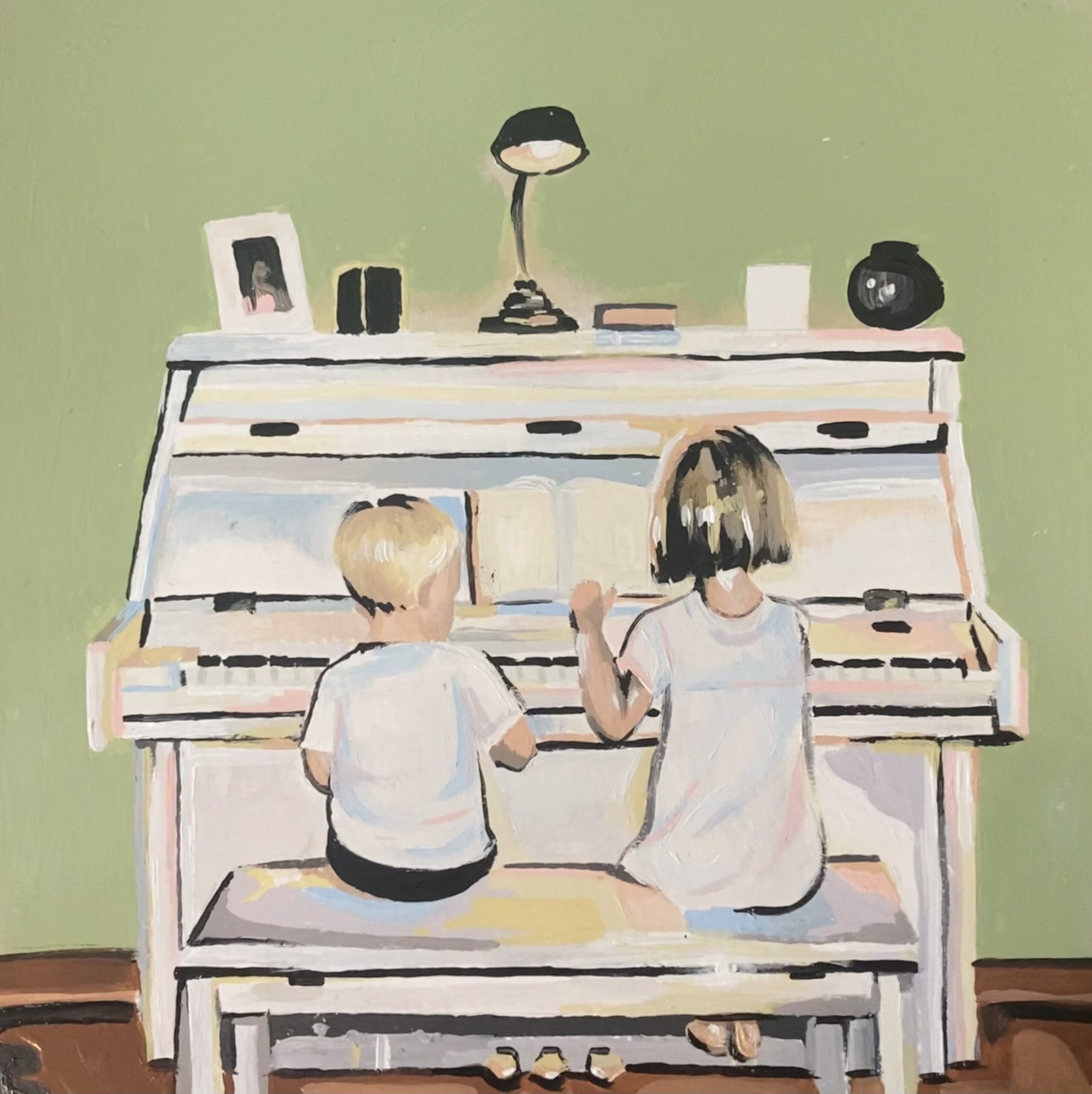 Young boy and girl sitting on a bench playing the piano