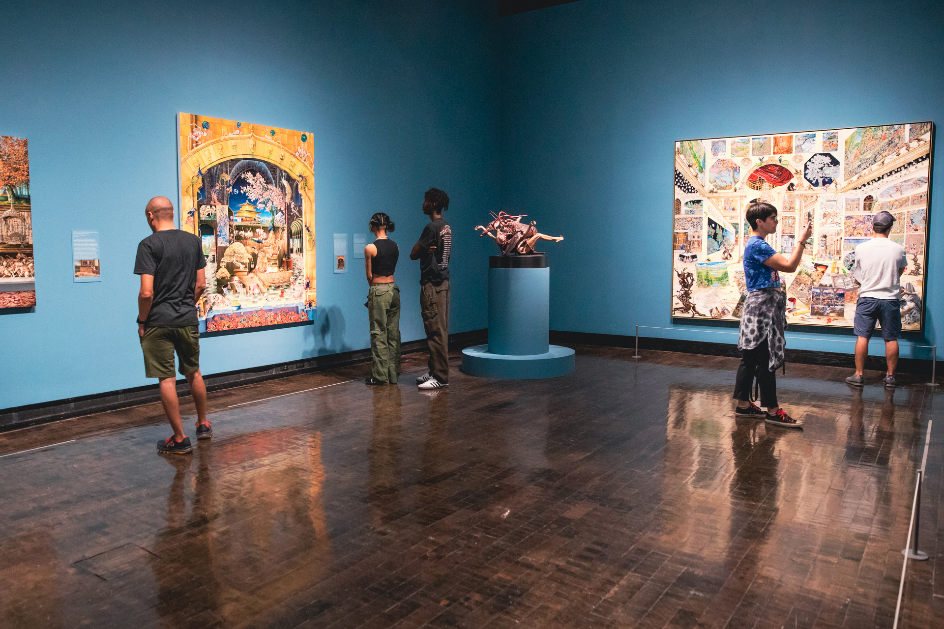 People looking at artwork in the Raqib Shaw exhibition