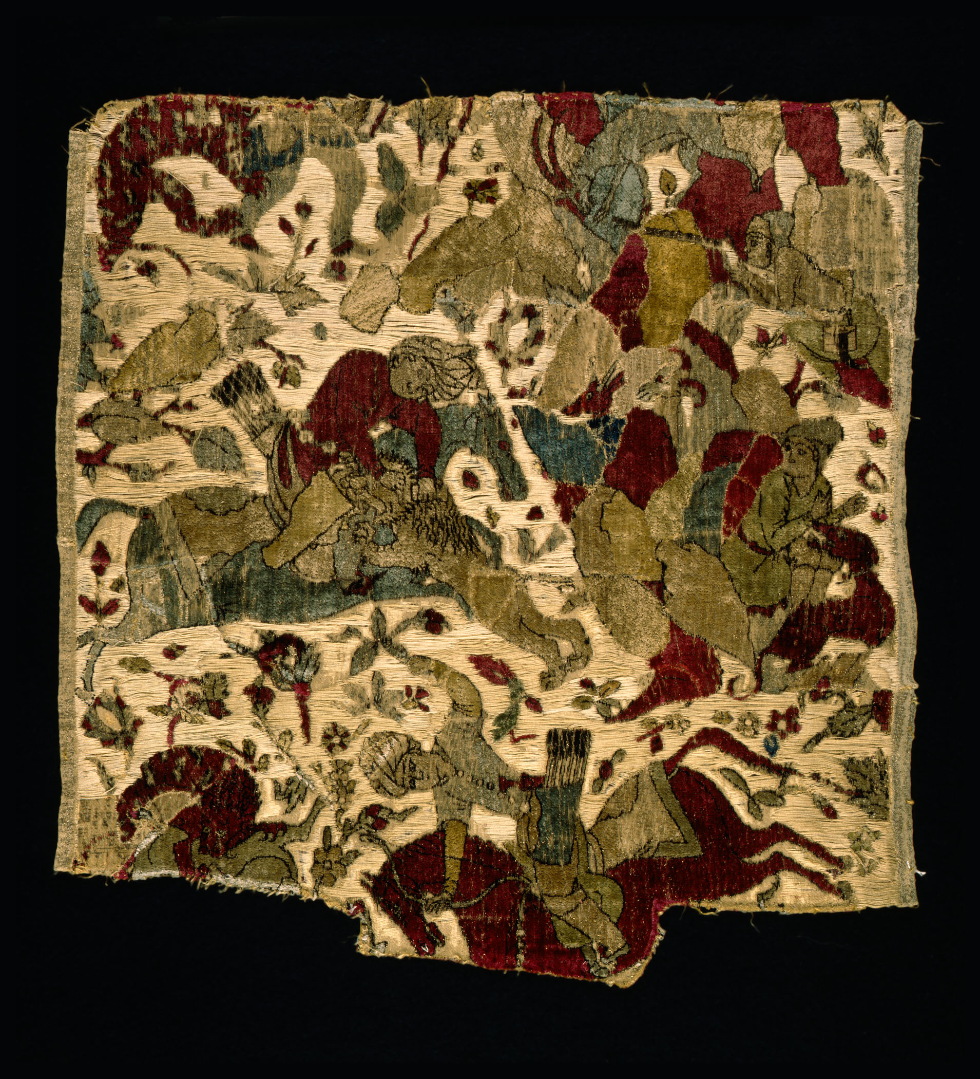 A rich textured velvet piece of cloth with blurred depictions animal and human shaped figures.