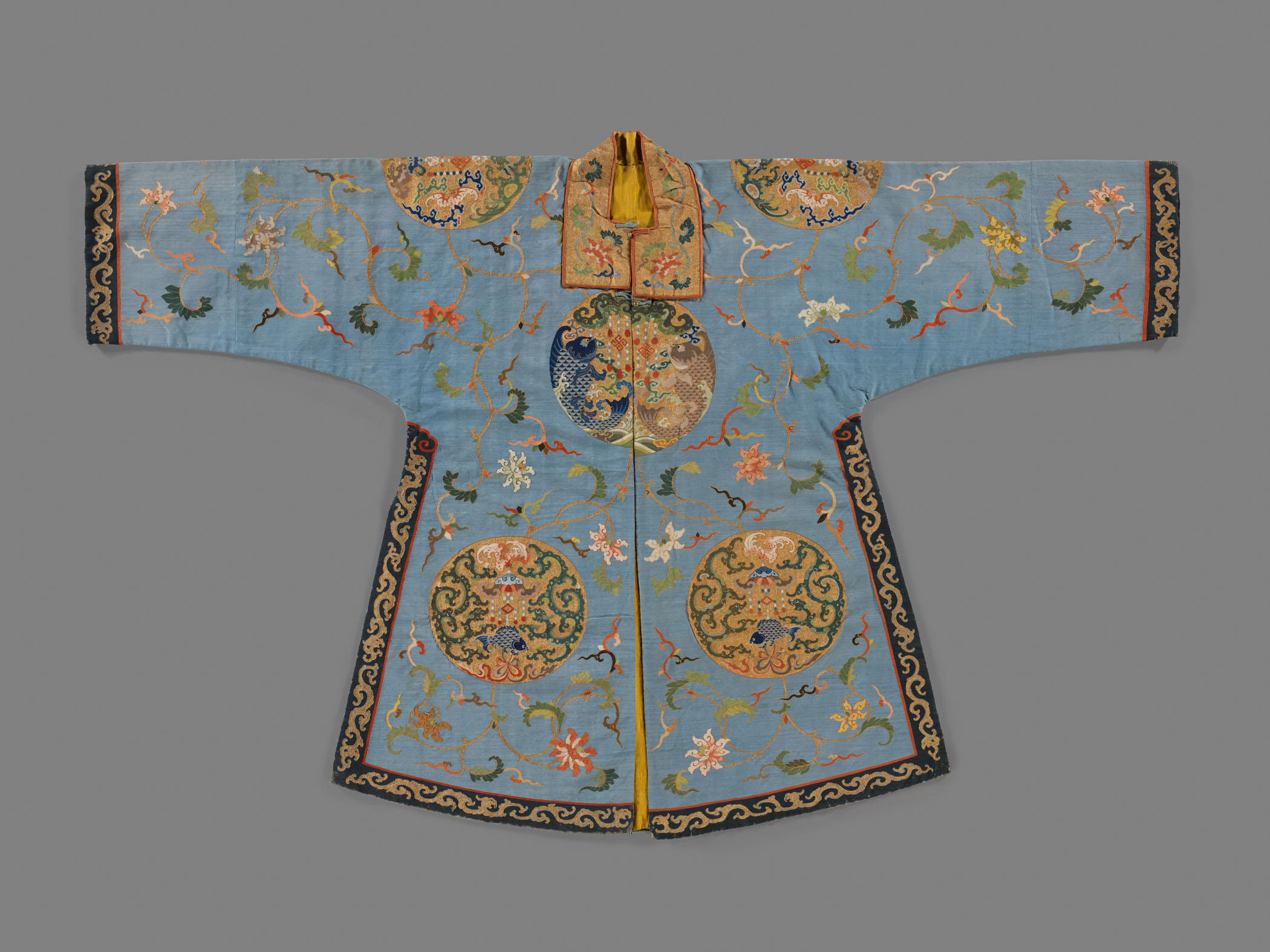 A light blue coat that is filled with Chinese style flowers and décor.