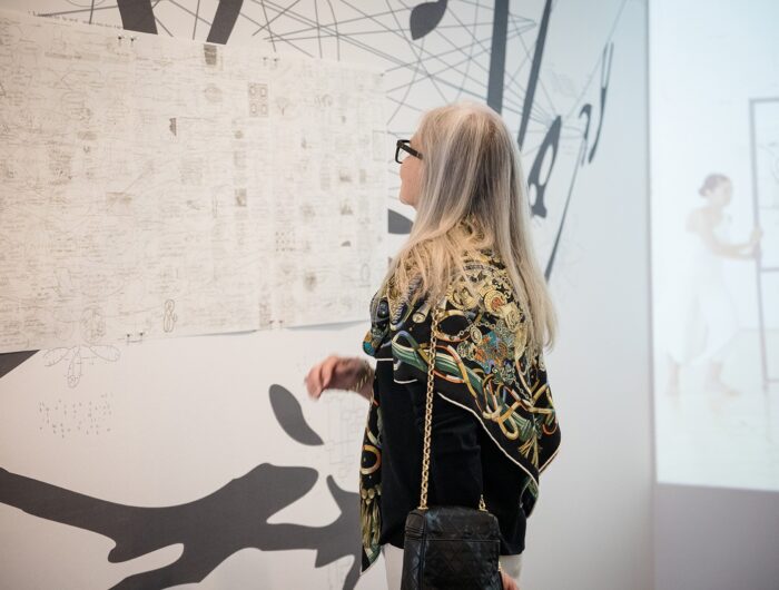 Woman looking closely at a detailed drawing