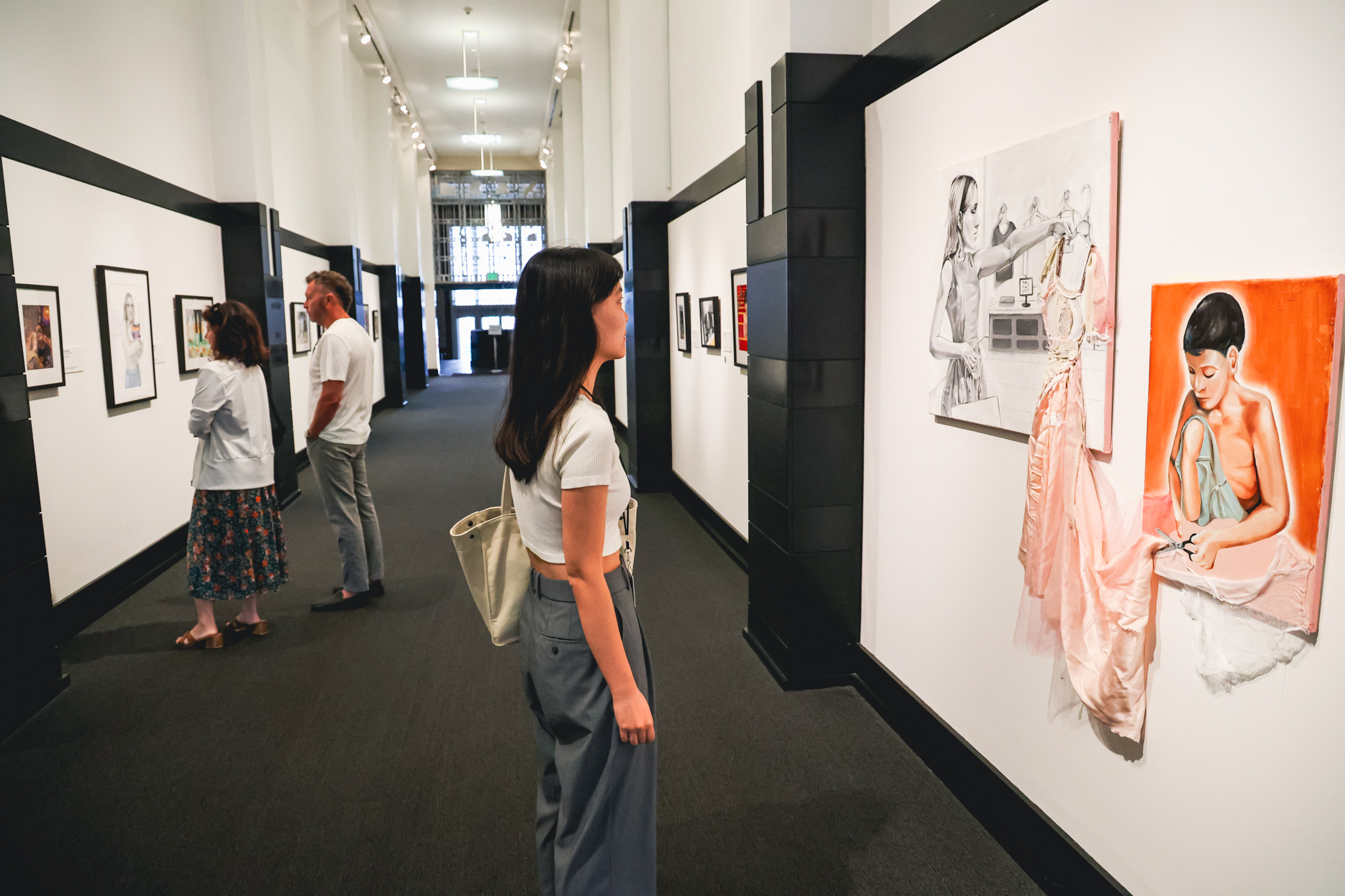 Young woman looking at a work of art