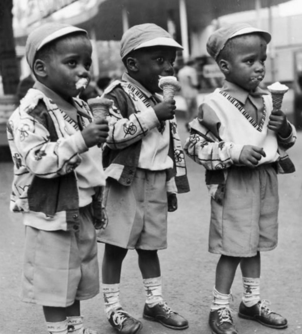 Three young African American boys eating ice cream cones
